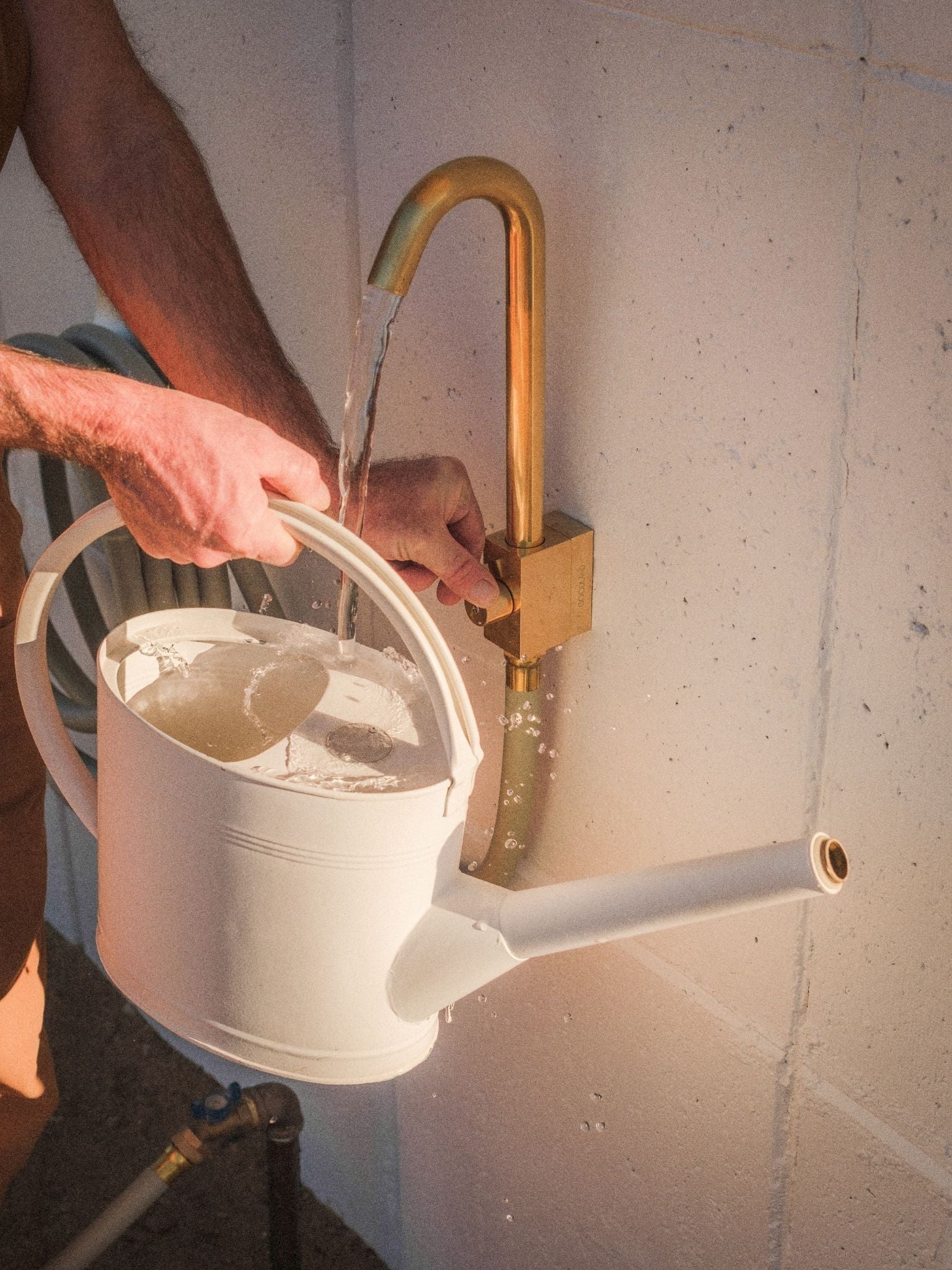 brass outdoor water faucet filling watering can