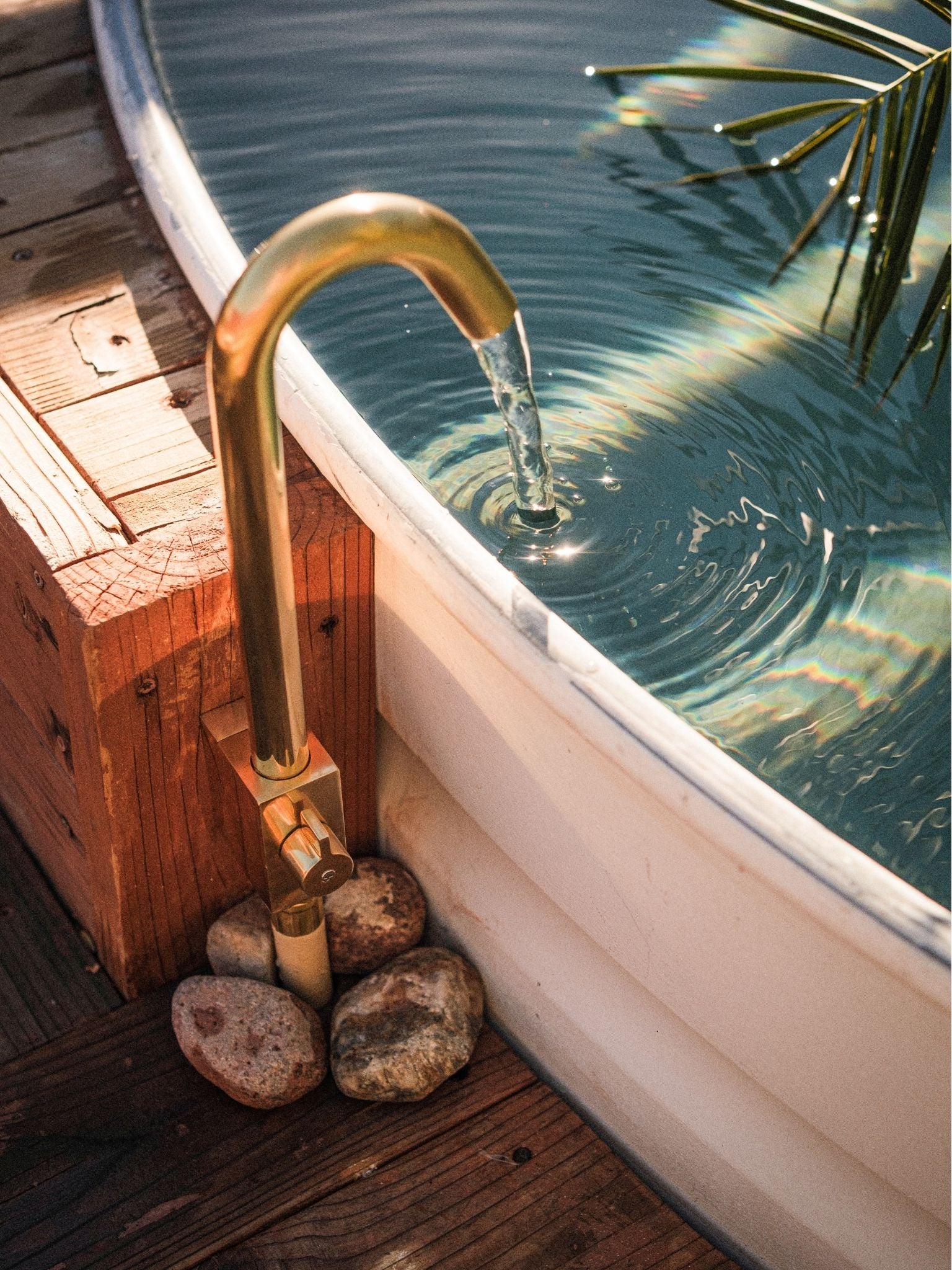 brass outdoor faucet filling small pool