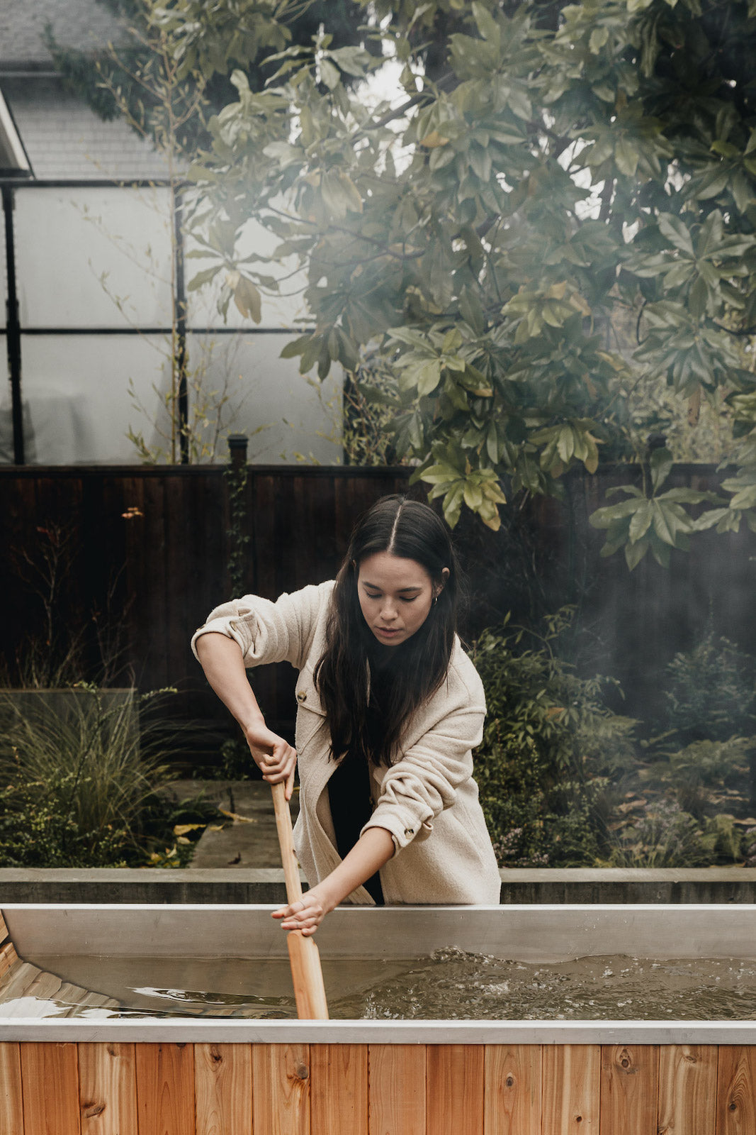 stirring water in wood fired hot tub