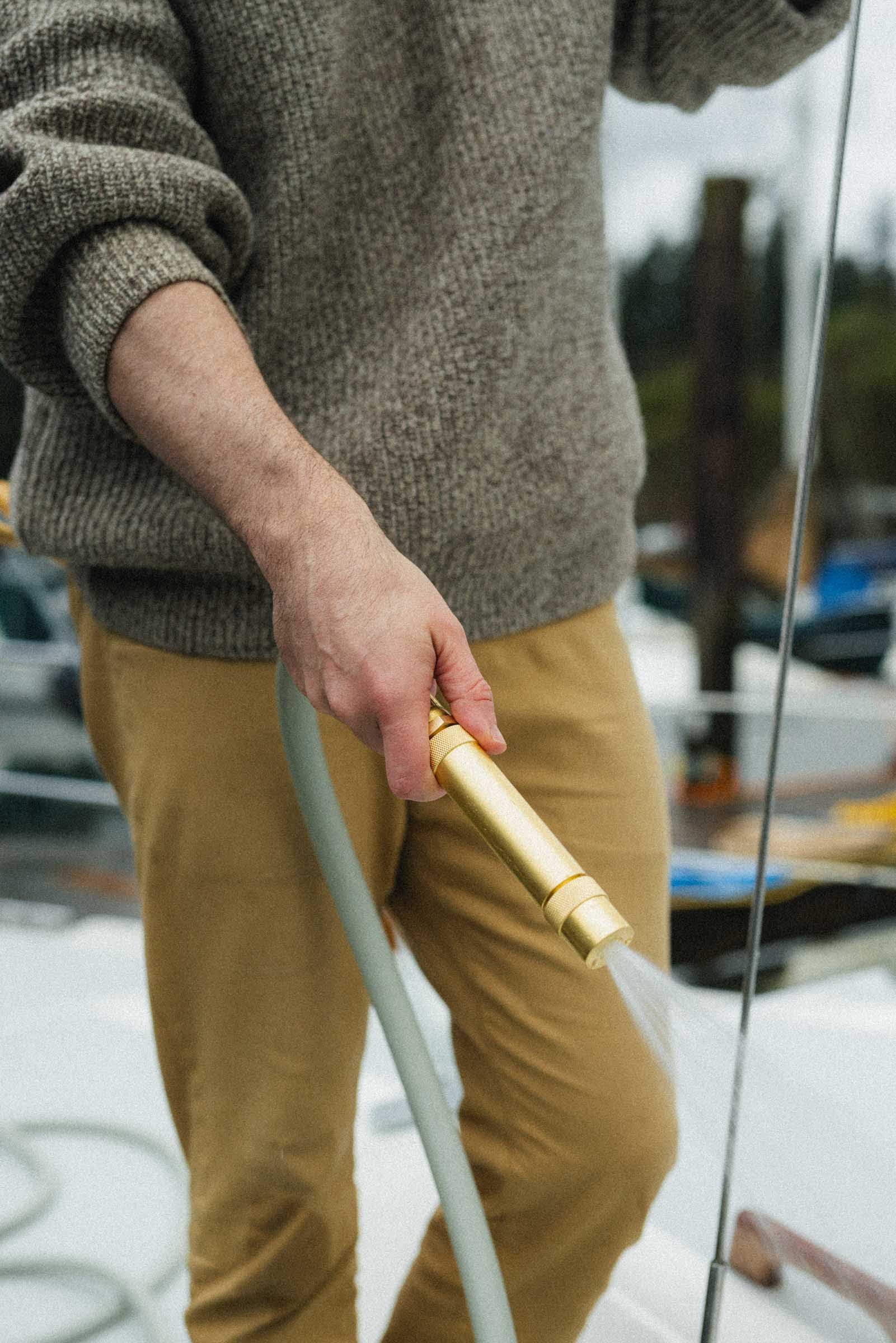 brass hose nozzle on green garden hose