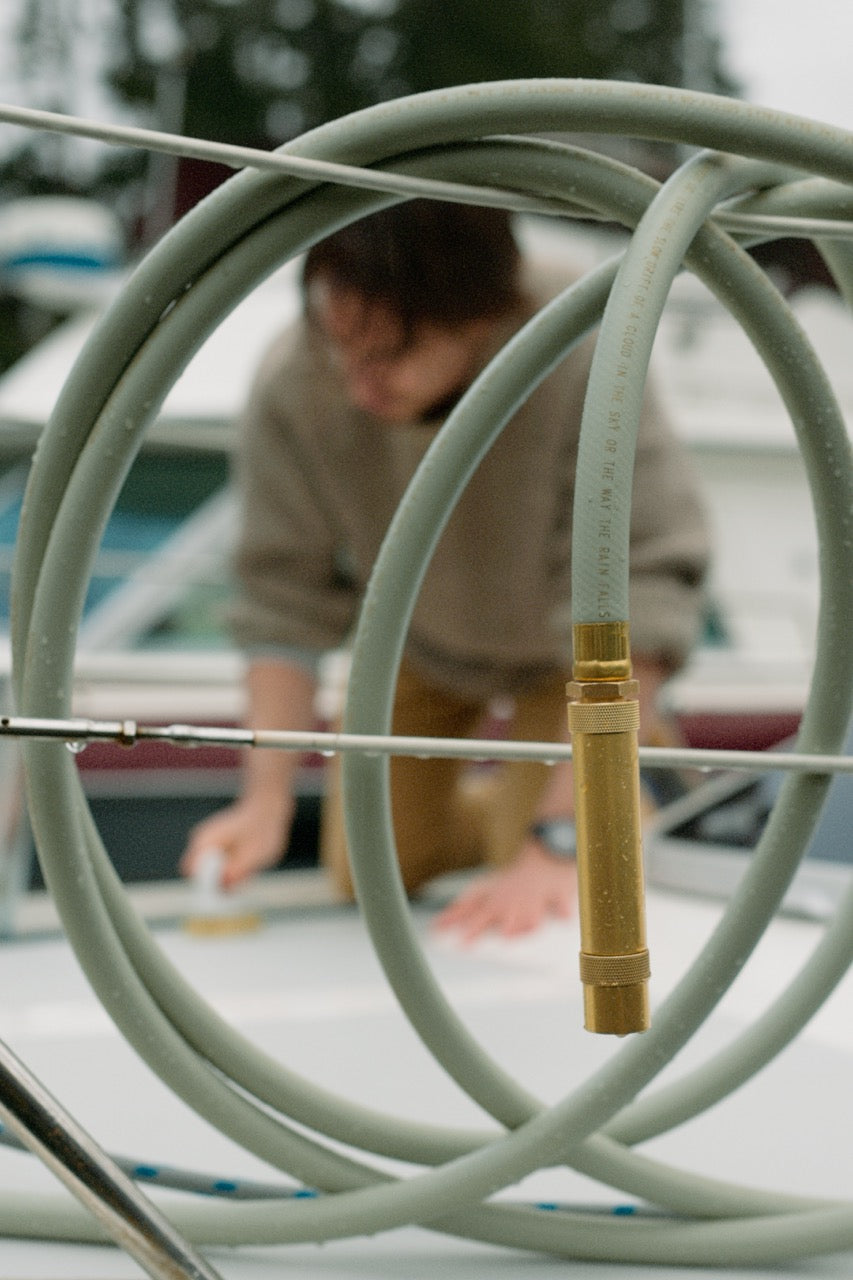 brass hose nozzle on green garden hose