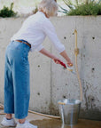 50 ft garden hose that's made in Canada attached to brass outdoor faucet