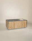 freestanding soaking tub made of stainless steel and red cedar