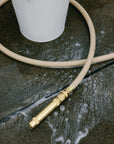 High quality garden hose for all purpose use next to a bucket