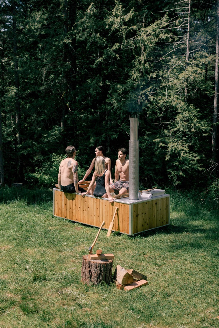 4 people in wood fired hot tub outdoors