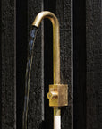 Brass hose bib that's also drinking water safe attached to a wall