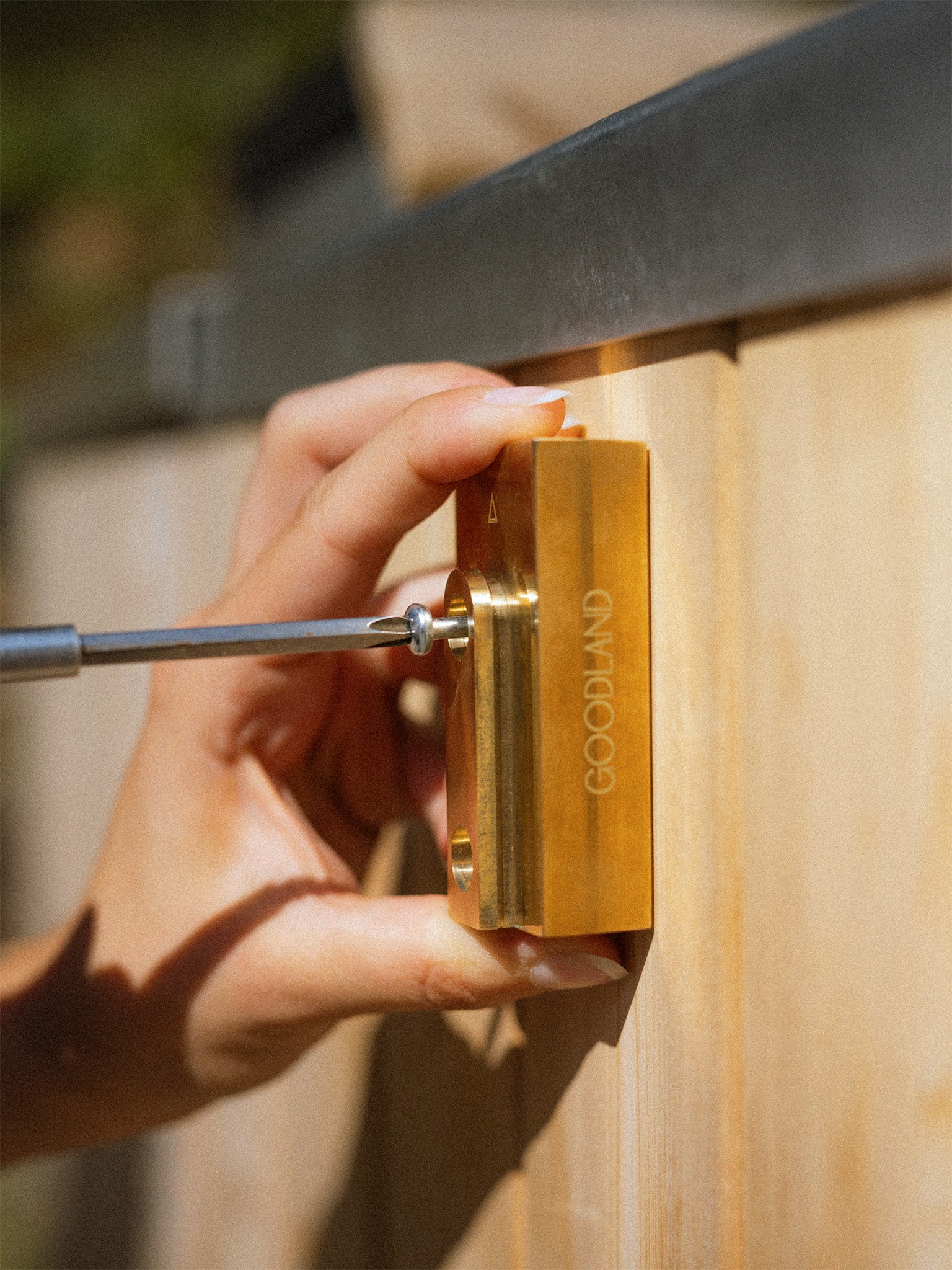 placing screws into brass mounting block