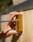 placing screws into brass mounting block