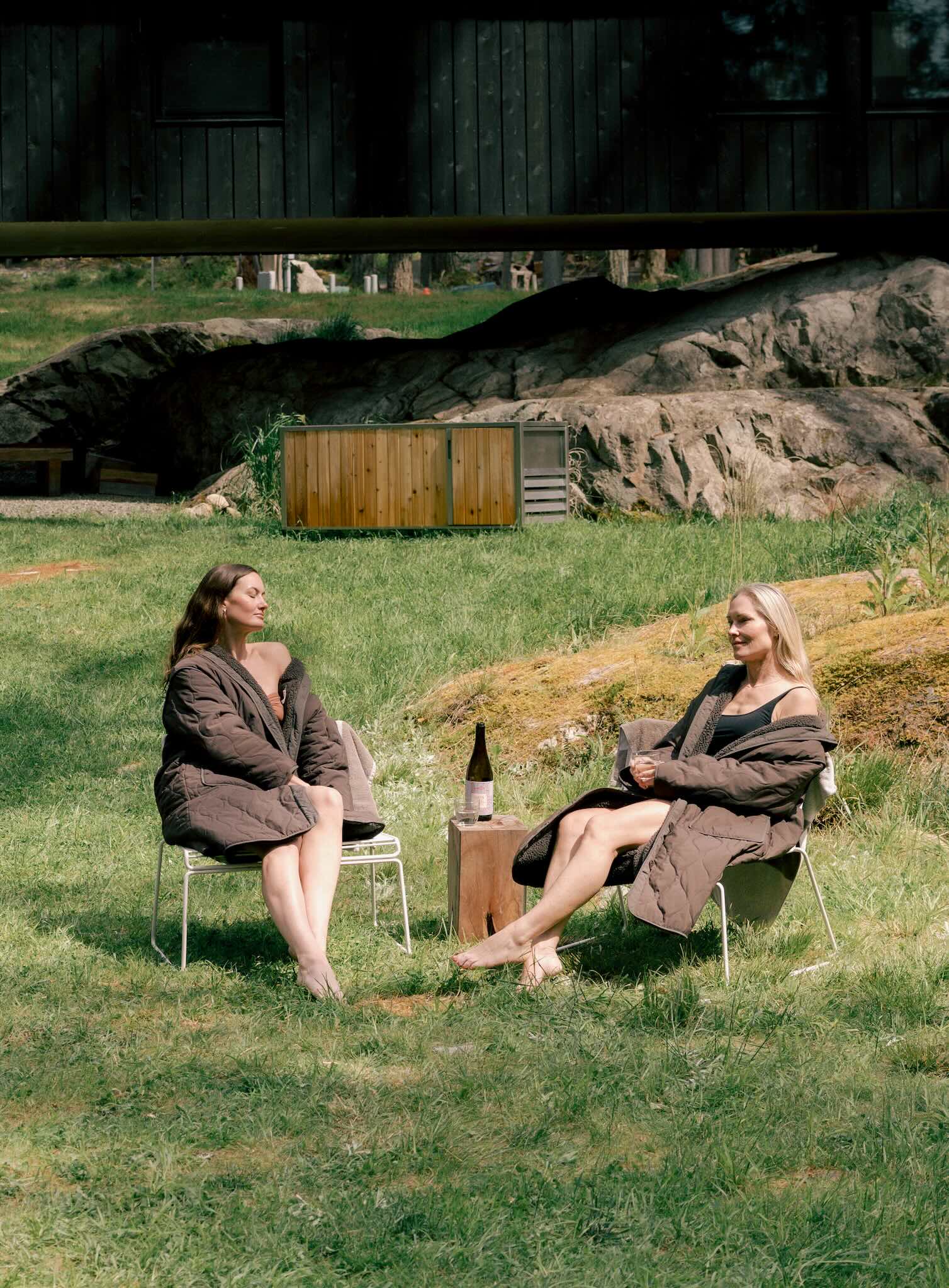 two people wearing warm swimming robes outdoors