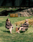 two people wearing warm swimming robes outdoors