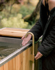 Cold plunge tub filler brass faucet attached to a garden hose