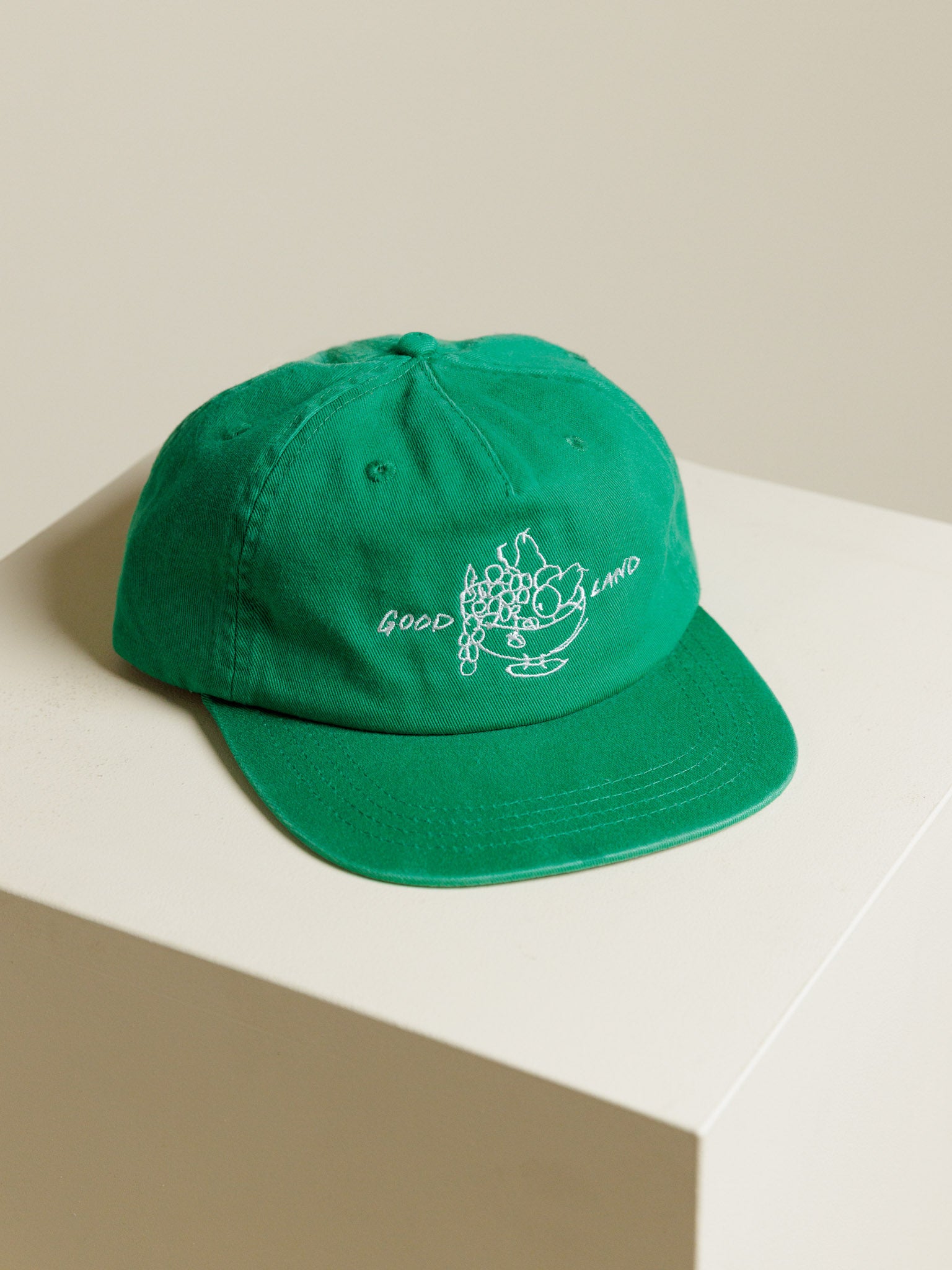 Green baseball hat from GOODLAND with illustration from Canaan Pine