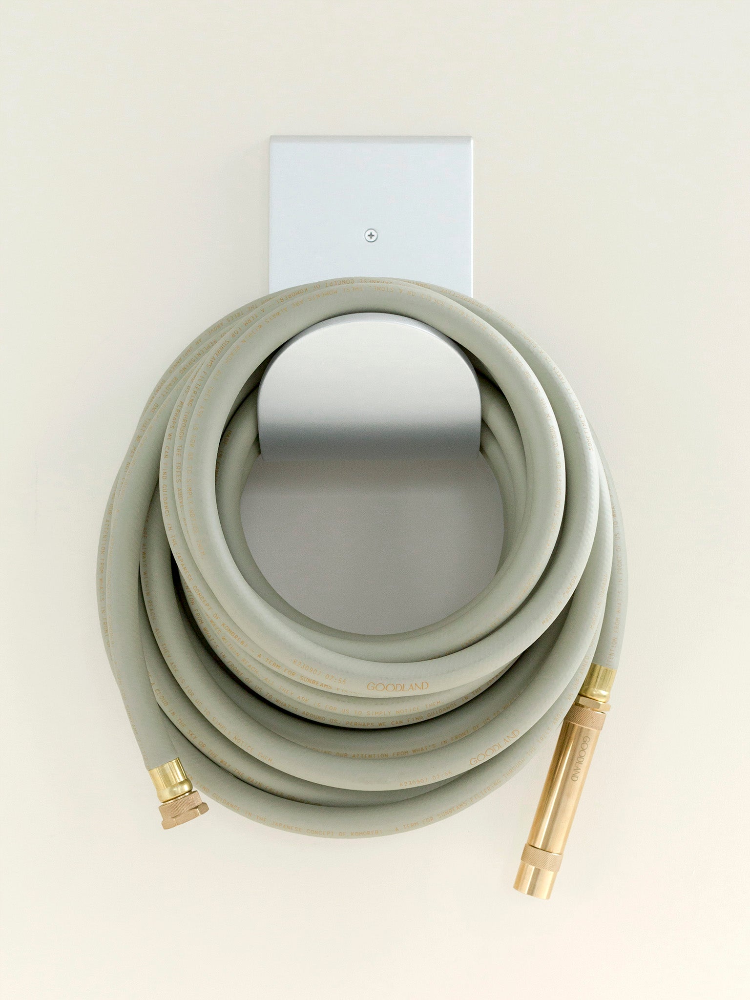 green garden hose on hose hanger