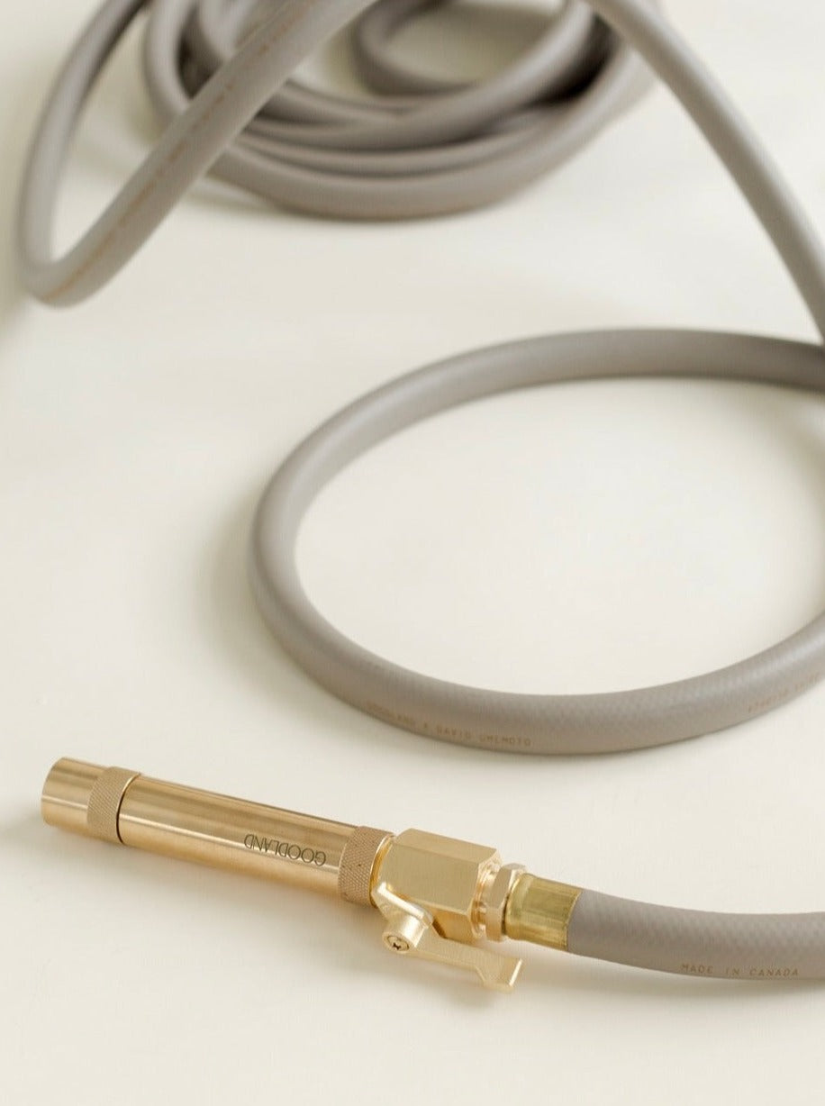 gray garden hose with brass fittings