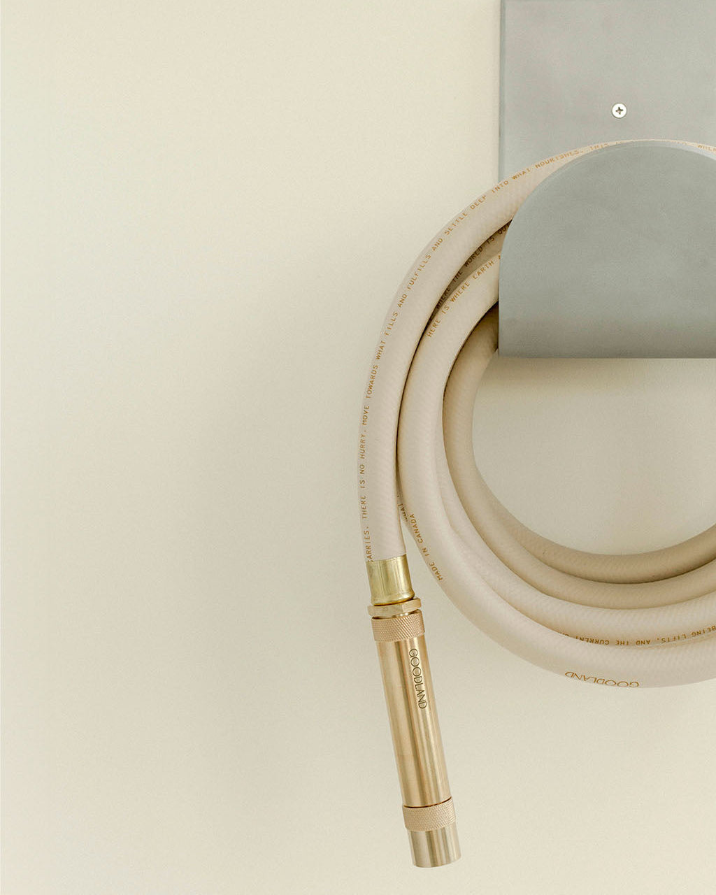 brass hose nozzle on tan garden hose