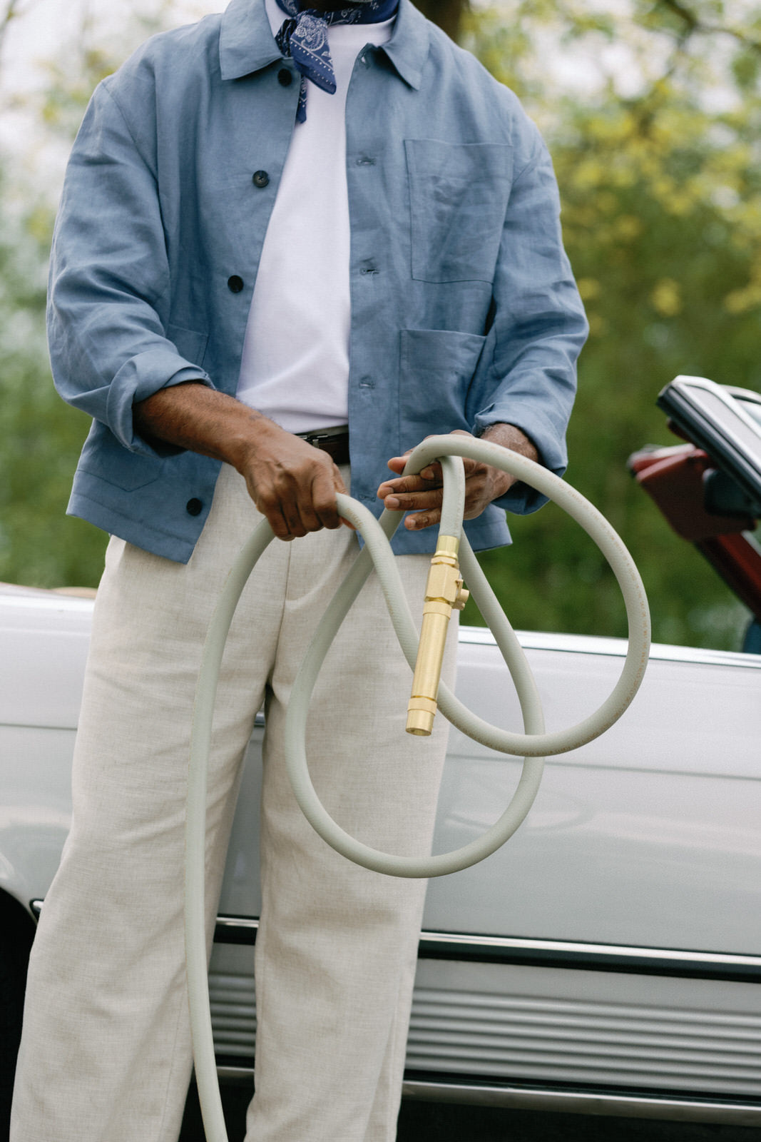 Man holding durable kink resistant garden hose with brass fittings
