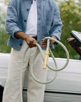 Man holding durable kink resistant garden hose with brass fittings