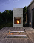 two built in soaking tubs with faucets by an outdoor fireplace