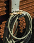 Garden hose nozzle on green water hose