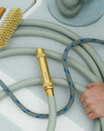 Solid brass garden hose nozzle on green water hose