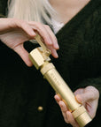 Brass shut off valve for garden hose attached to a nozzle