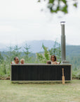 wood burning hot tub with two adults and two small children 