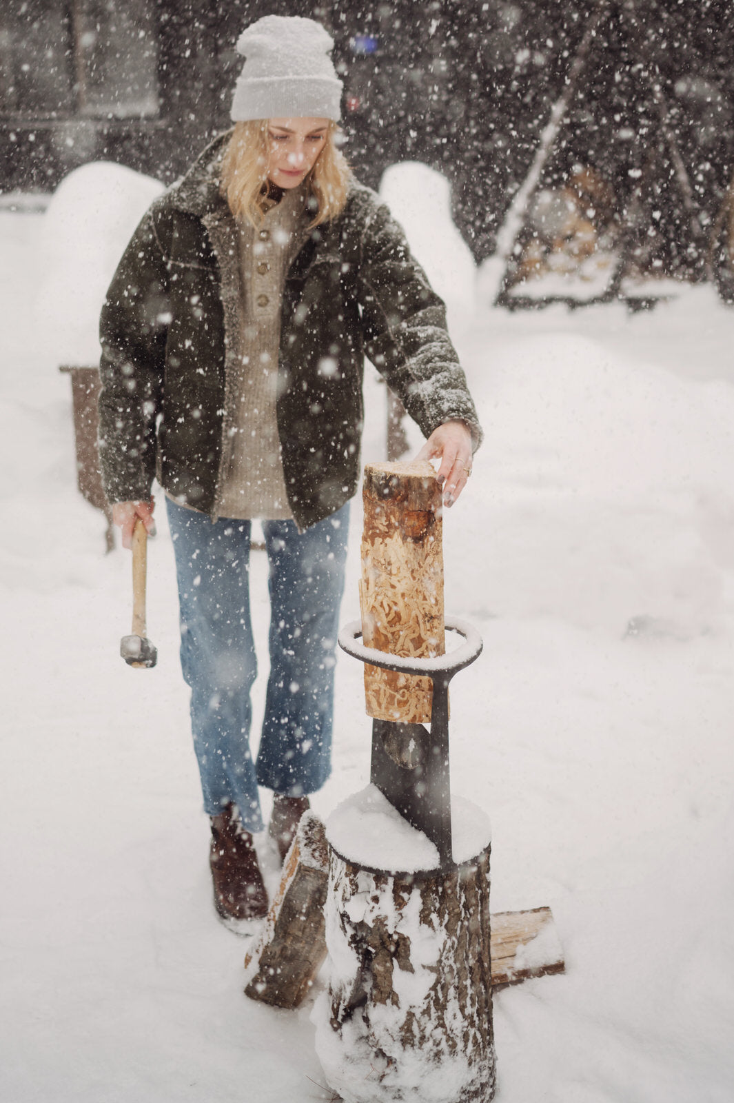 winter firewood splitter in snow