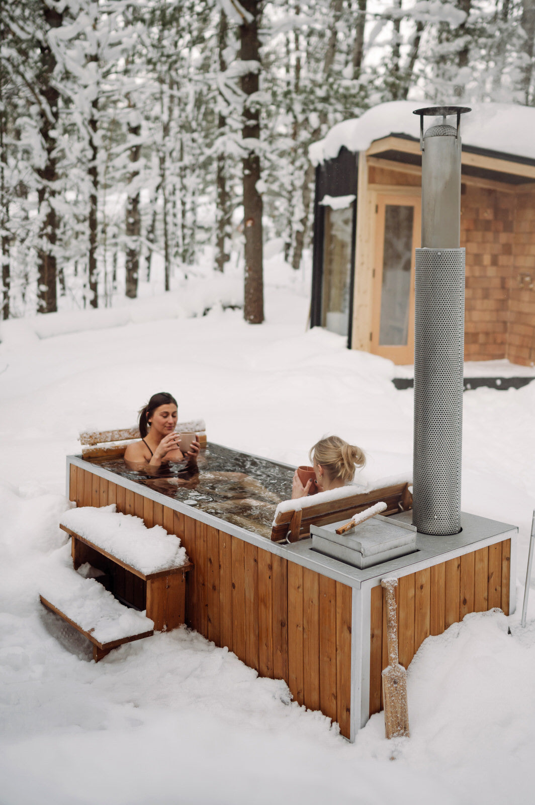 winter cedar wood burning hot tub in the snow