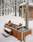 winter cedar wood burning hot tub in the snow
