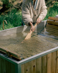 aluminum lined wood burning hot tub - stirring tub water 