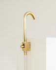 Brass outdoor faucet mounted and attached to a garden hose
