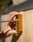 Brass mount for outdoor faucet being installed on a wood fired hot tub