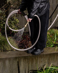Grey aesthetic long garden hose used for watering