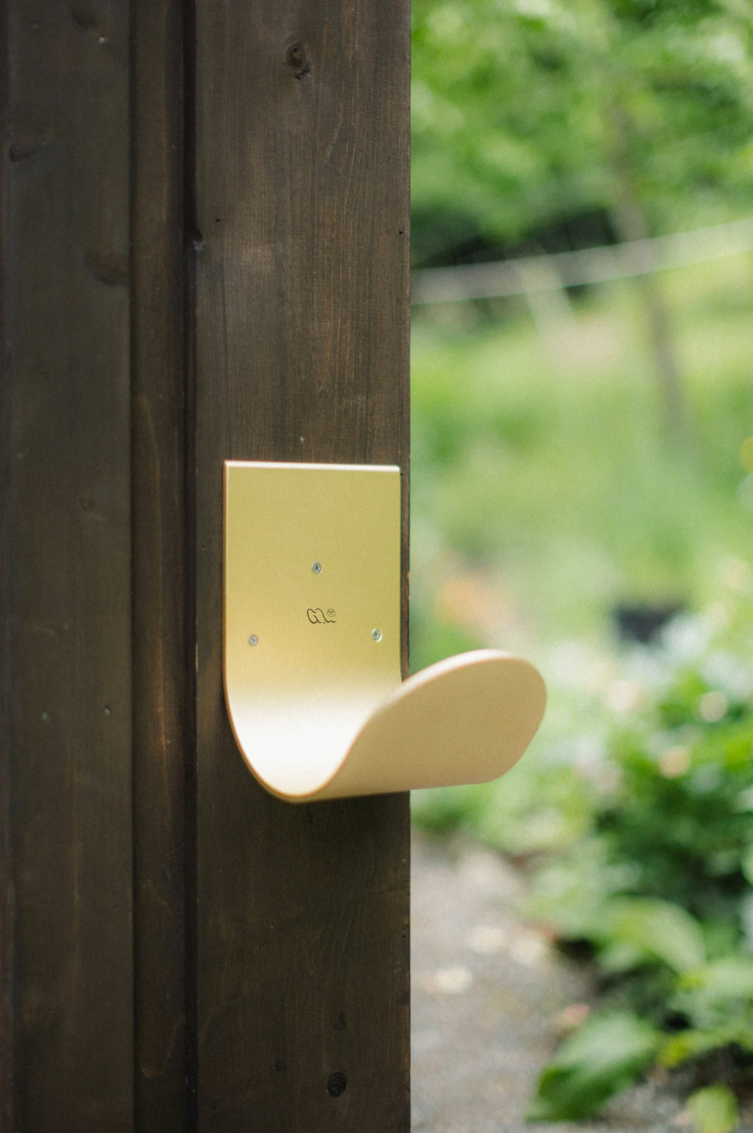 Modern wall mount hose holder with sculptural modern shape