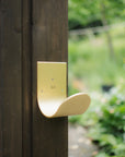 Modern wall mount hose holder with sculptural modern shape 