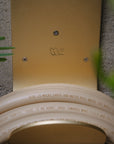 Brass garden hose hook with a tan garden hose 